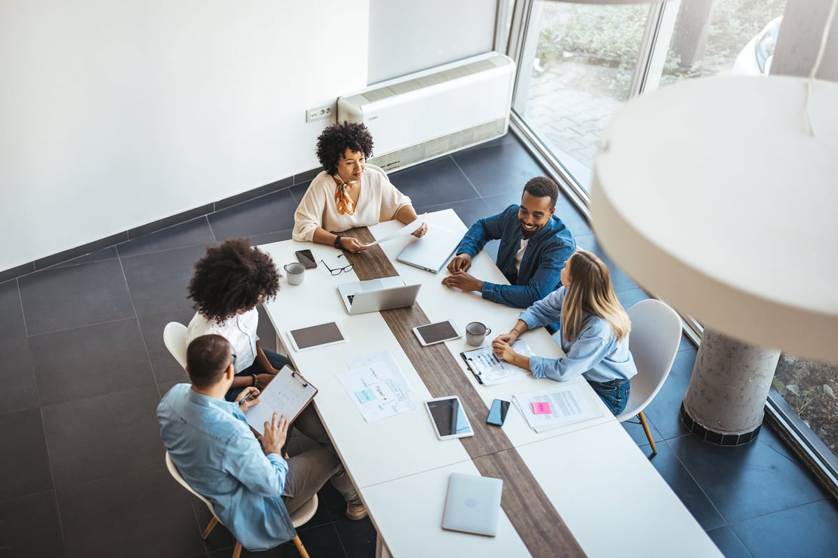 A diverse group of professionals engaged in a collaborative meeting in a modern office setting